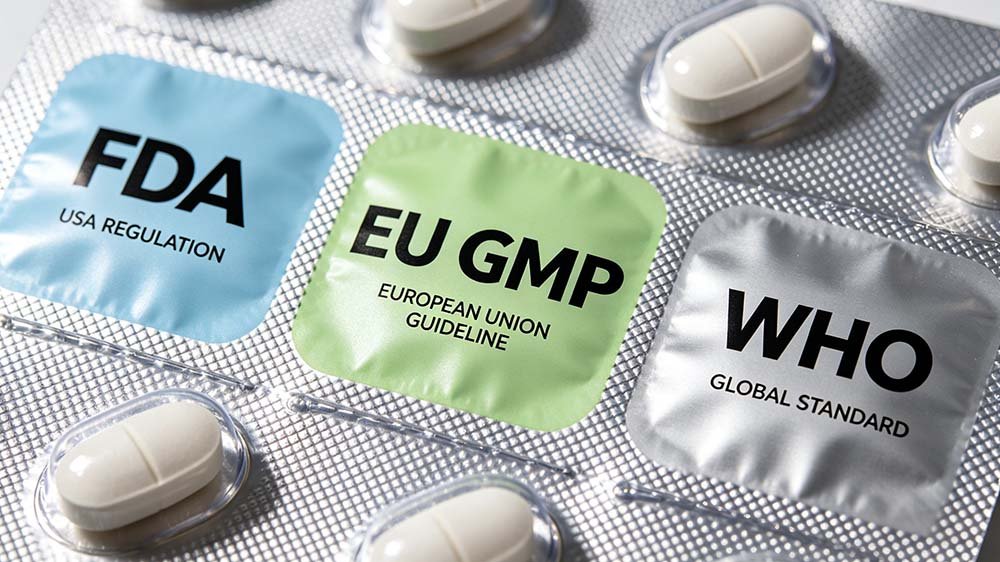 Close-up of a medicinal blister pack labeled with FDA, EU GMP, and WHO icons to illustrate pill blister packaging regulations FDA EU WHO。