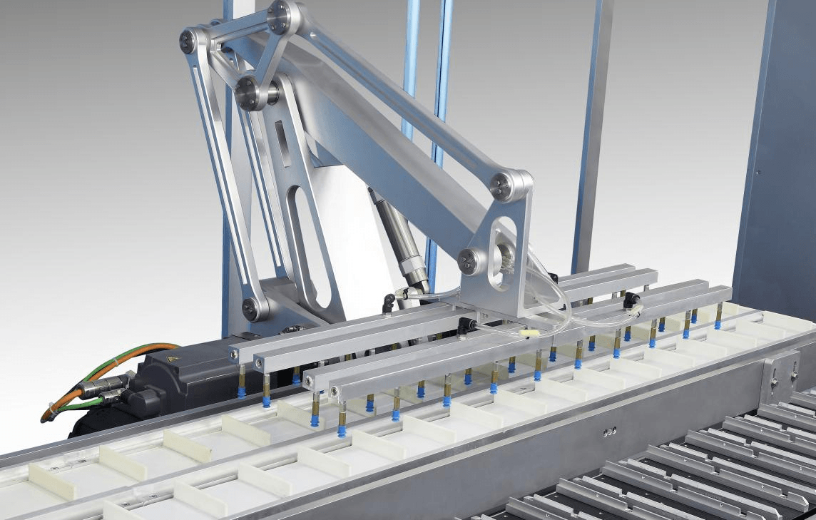 High-speed tracking manipulator transferring blister packs into cartoning machine compartments