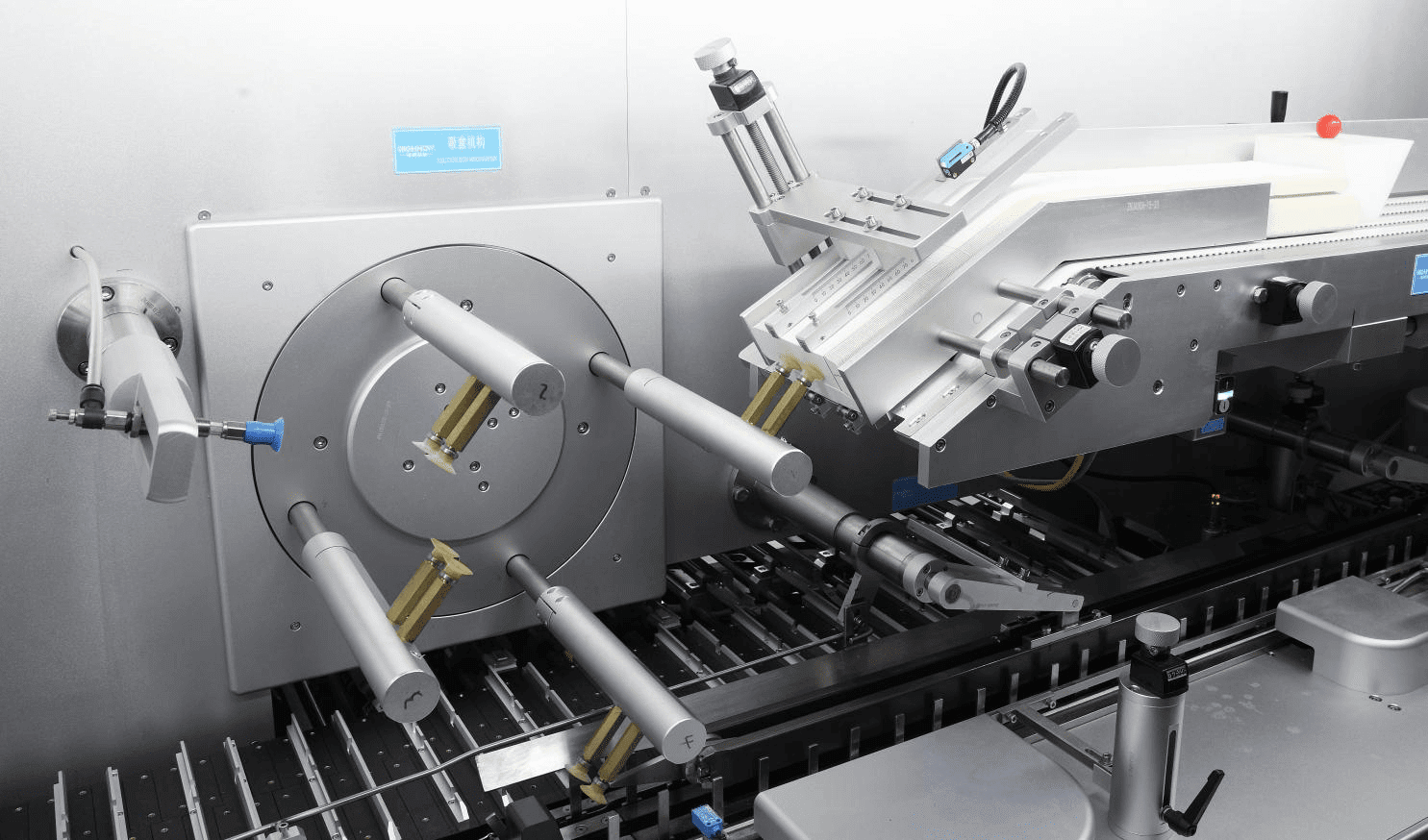 Rotary vacuum carton suction and opening mechanism on a blister cartoning machine