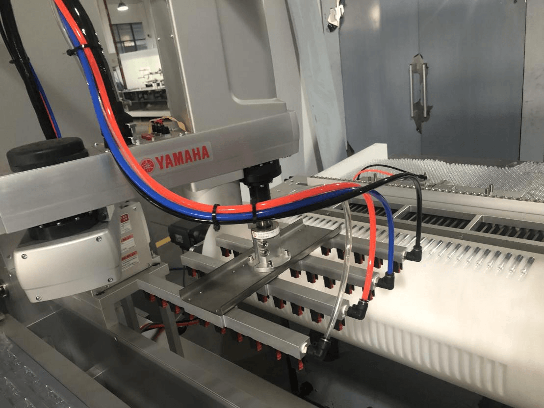 Yamaha robotic arm loading system on a Chinese-built blister cartoning line showing component convergence with European machines