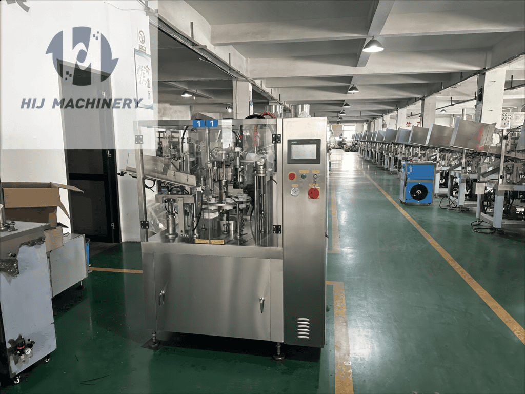 HIJ TF60 tube filling and sealing machine with guarded rotary stations in the workshop